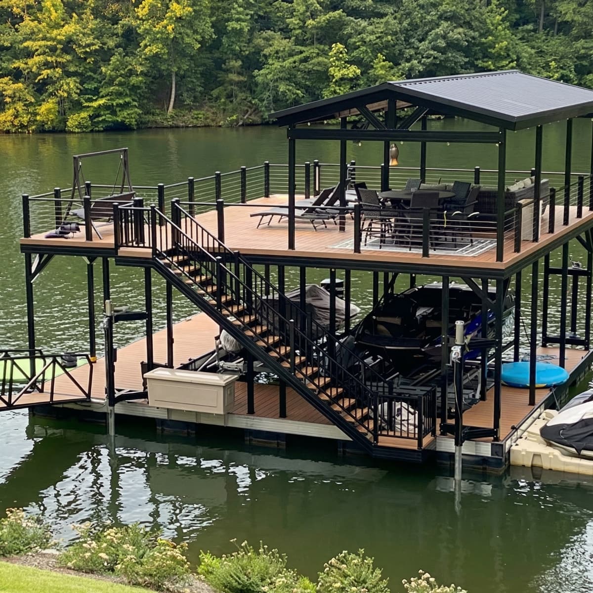 Custom aluminum dock house with rooftop deck and boat lift