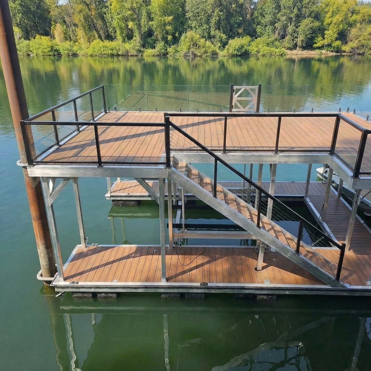 Two-level aluminum dock house with cable railings on river
