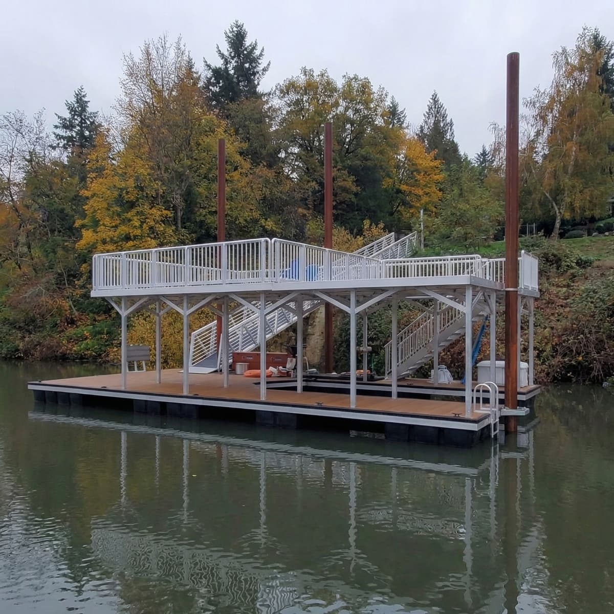 Custom two-level floating platform with aluminum railings and teak WPC